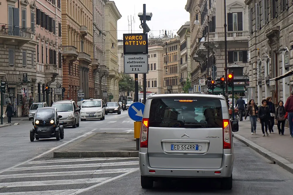An active ZTL gate in Rome: a “varco attivo” sign and enforcement camera above the street
